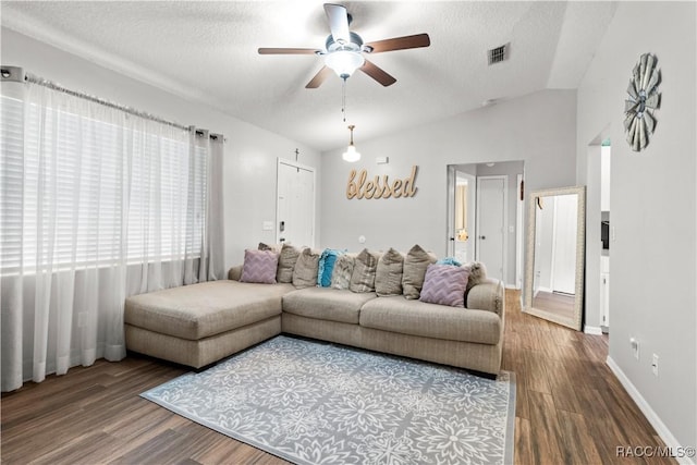 living room featuring hardwood / wood-style floors, a textured ceiling, ceiling fan, and vaulted ceiling