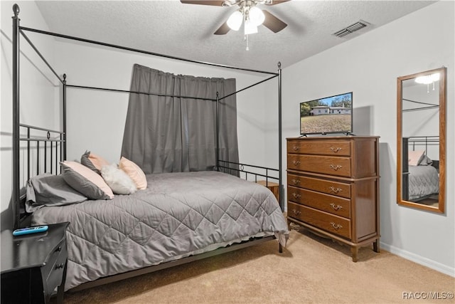 carpeted bedroom with a textured ceiling and ceiling fan