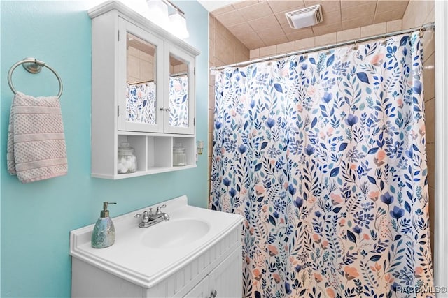 bathroom with walk in shower and vanity