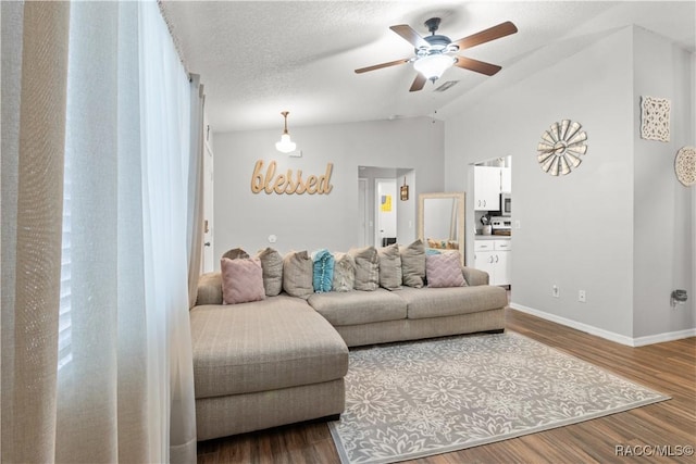 living room featuring wood-type flooring, a textured ceiling, ceiling fan, and vaulted ceiling