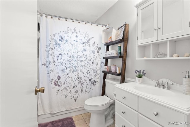 full bathroom with toilet, shower / bath combo with shower curtain, tile patterned floors, and vanity