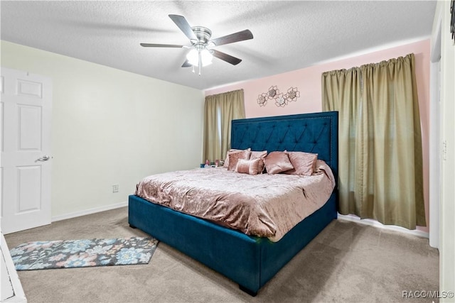 bedroom with a textured ceiling, ceiling fan, and carpet