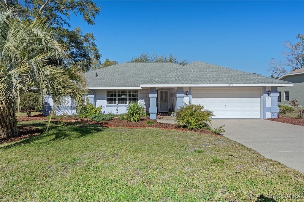 ranch-style house with a garage and a front yard