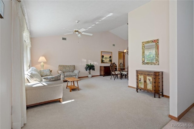 living room featuring ceiling fan, vaulted ceiling, and carpet floors