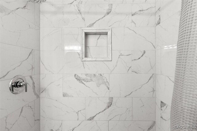 full bathroom with a tile shower
