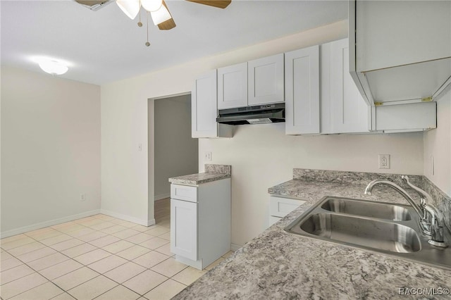 3410 N Bay Ave, Crystal River, FL 34428 - kitchen featuring under cabinet range hood, a ceiling fan, light tile patterned floors, and light countertops