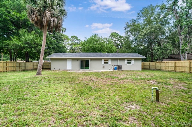 3410 N Bay Ave, Crystal River, FL 34428 - rear view of property featuring stucco siding, a fenced backyard, and view of scattered trees