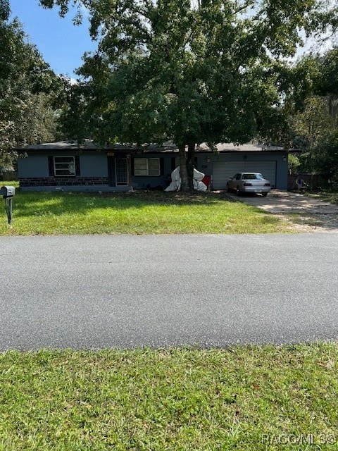 view of front of property featuring a garage and a front lawn