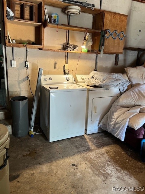 clothes washing area featuring separate washer and dryer