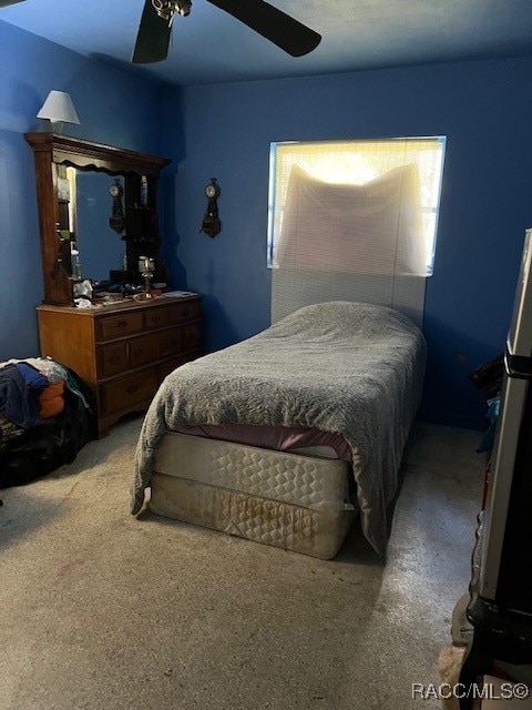 bedroom featuring ceiling fan and light carpet