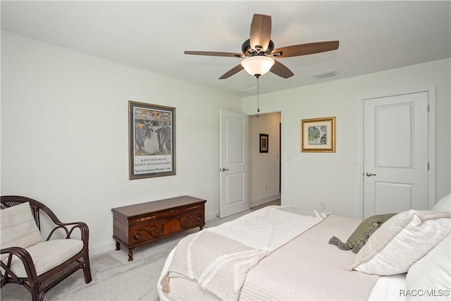 bedroom with a ceiling fan, light colored carpet, visible vents, and baseboards