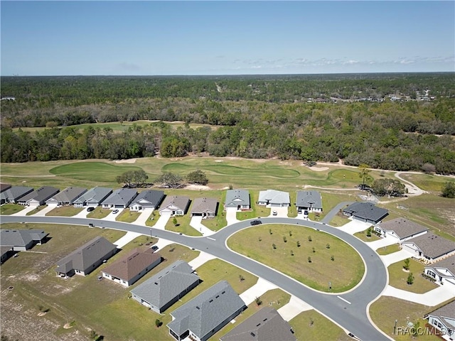 aerial view with a residential view, a view of trees, and view of golf course