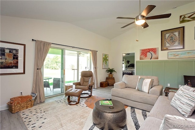 living room with ceiling fan, lofted ceiling, and wood finished floors