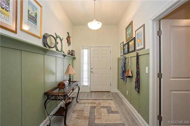 entrance foyer featuring baseboards and light wood-style floors