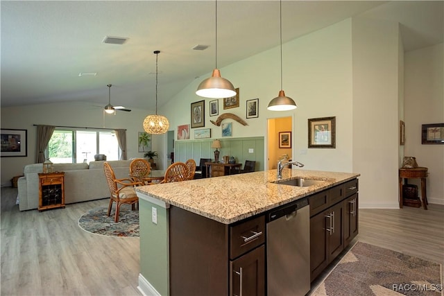 kitchen featuring ceiling fan, dark brown cabinetry, light wood-type flooring, stainless steel dishwasher, and a sink