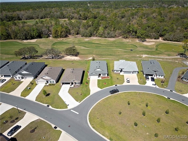 drone / aerial view with a forest view, a residential view, and golf course view