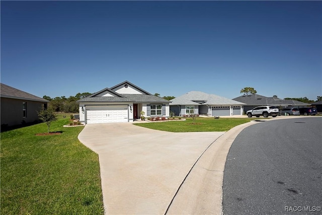 view of front facade with a front lawn, a garage, and driveway