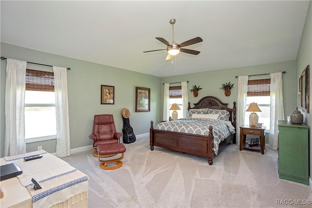 bedroom featuring light carpet, ceiling fan, and baseboards