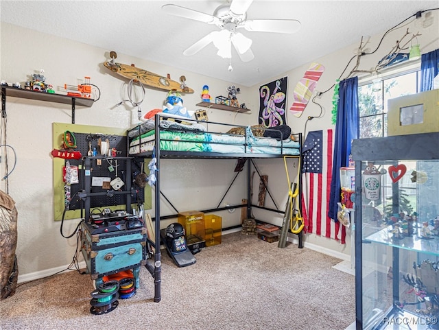 carpeted bedroom with a textured ceiling and ceiling fan