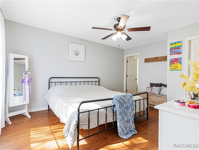 bedroom with hardwood / wood-style floors and ceiling fan