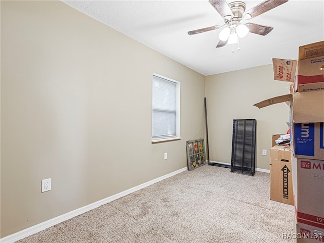 interior space with light carpet and ceiling fan