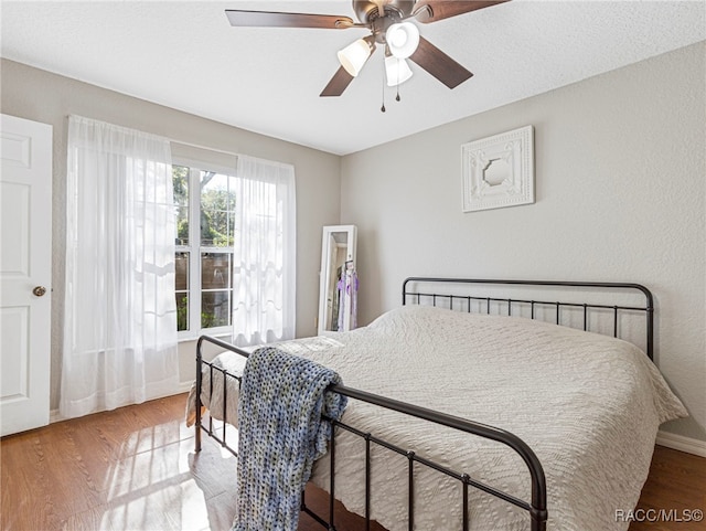 bedroom featuring wood-type flooring and ceiling fan