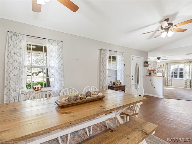 unfurnished dining area with a healthy amount of sunlight, lofted ceiling, and wood-type flooring