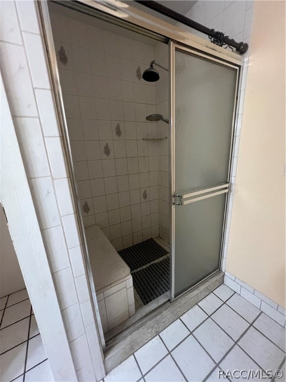 bathroom featuring tile patterned flooring and a shower with shower door