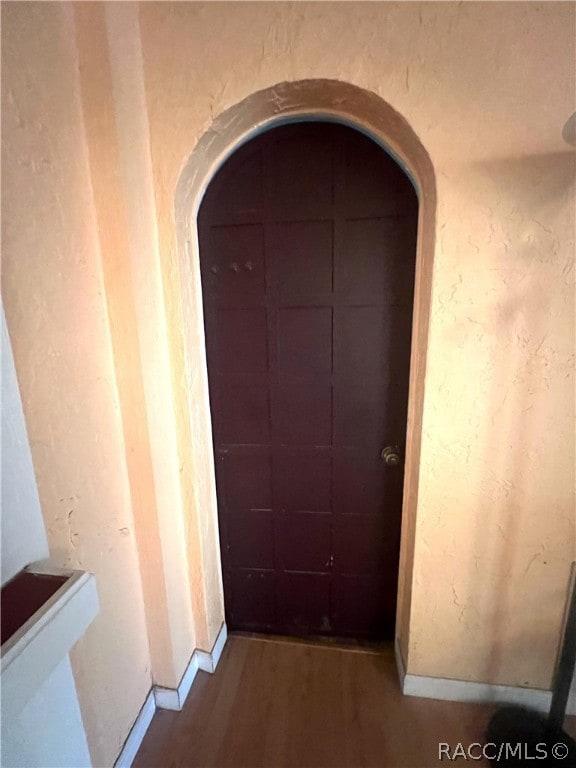 hallway with wood-type flooring