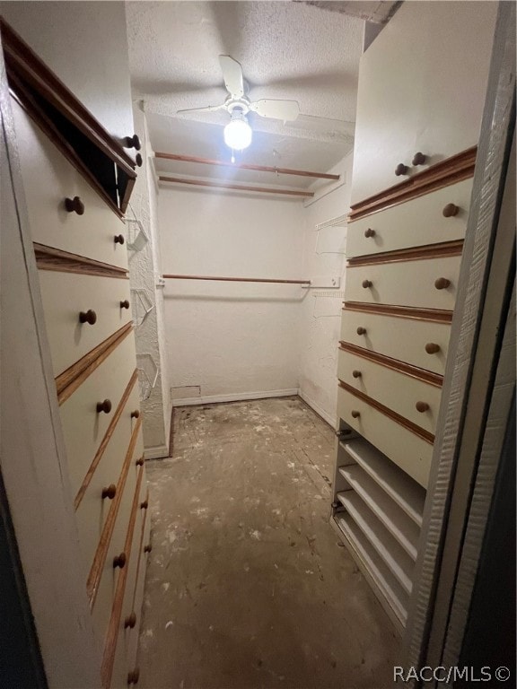 walk in closet with ceiling fan