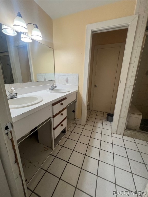 bathroom with tile patterned floors, vanity, and walk in shower