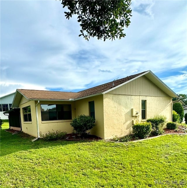 view of home's exterior with a lawn