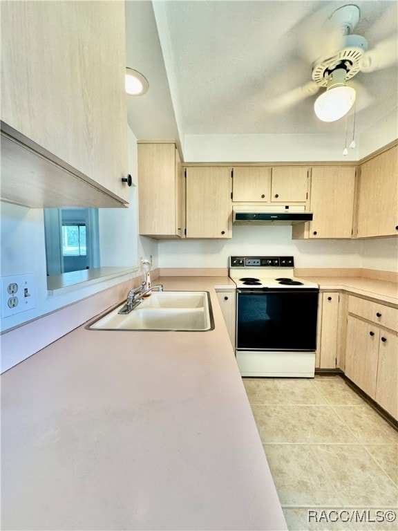 kitchen featuring white range with electric stovetop, light tile patterned floors, sink, and light brown cabinetry