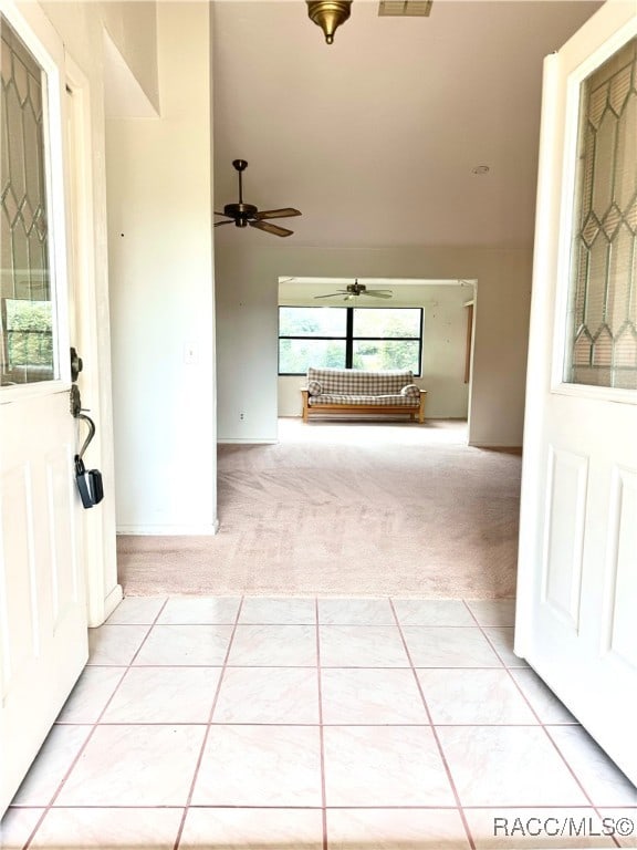 carpeted foyer featuring ceiling fan