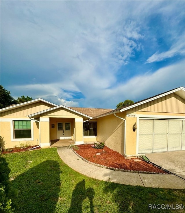 ranch-style house with a garage and a front yard