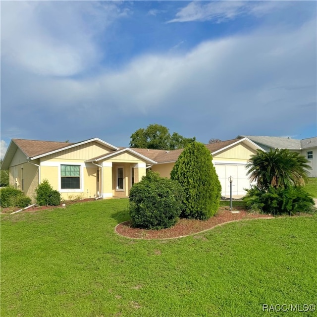 single story home with a garage and a front yard