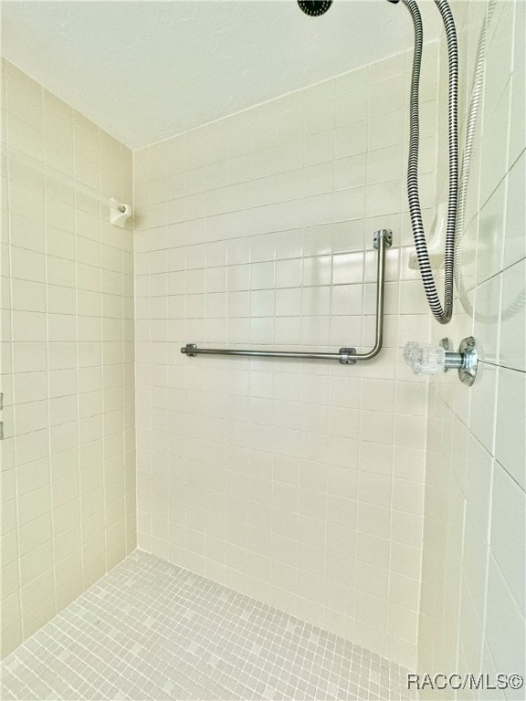 bathroom with a tile shower