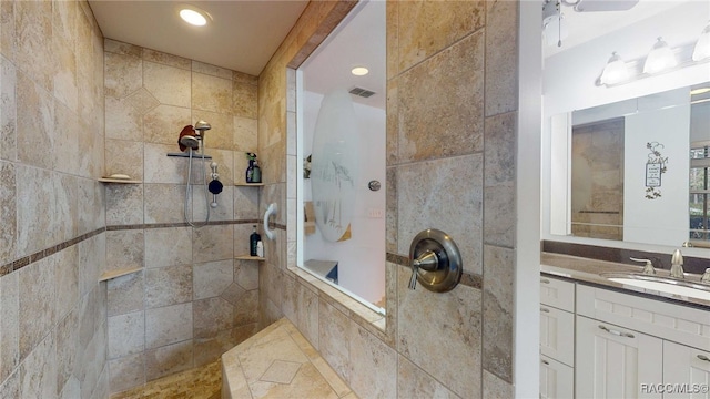 bathroom featuring vanity and a tile shower