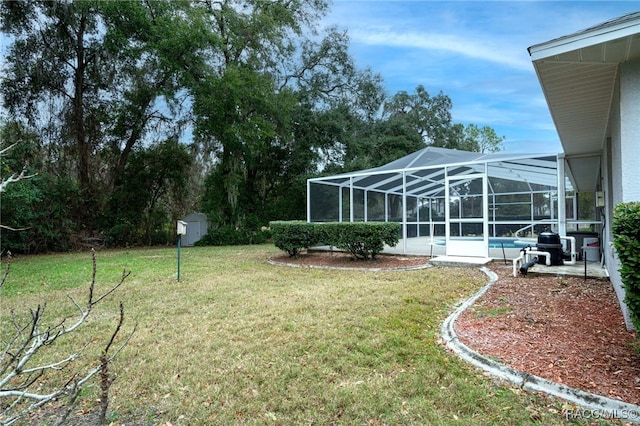 view of yard featuring a lanai and a shed