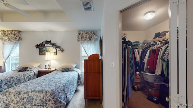 bedroom with ceiling fan, carpet flooring, a closet, and multiple windows