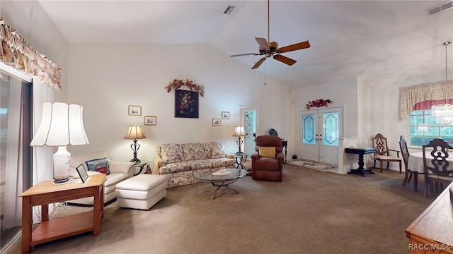 carpeted living room with ceiling fan, french doors, and vaulted ceiling