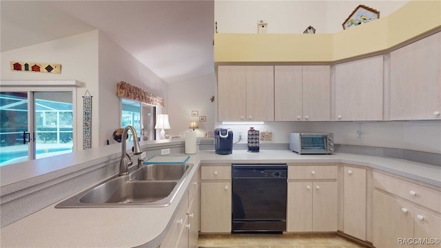 kitchen featuring sink, kitchen peninsula, dishwasher, and lofted ceiling