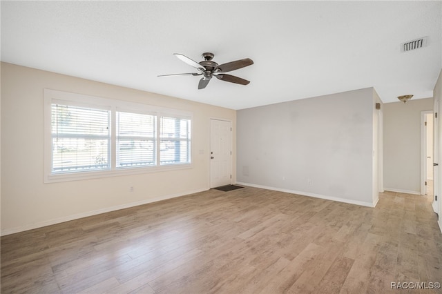 unfurnished room with ceiling fan and light wood-type flooring