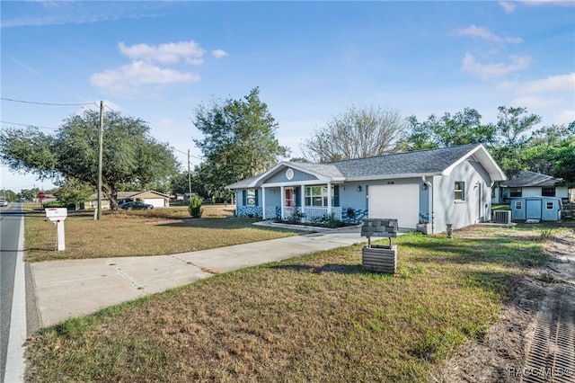 ranch-style home featuring cooling unit, a front lawn, a porch, and a garage