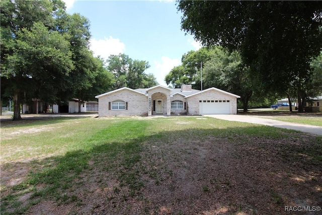 ranch-style house featuring a garage, a front yard, and driveway