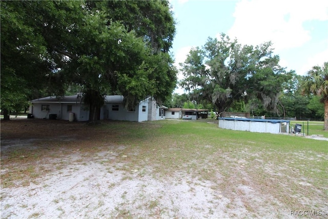 view of yard featuring a covered pool