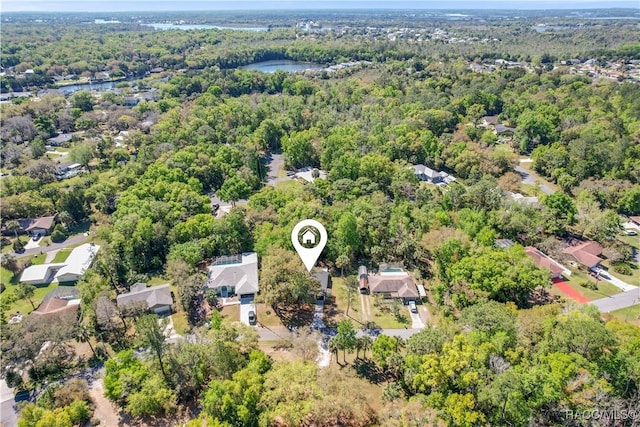 drone / aerial view featuring a residential view, a forest view, and a water view