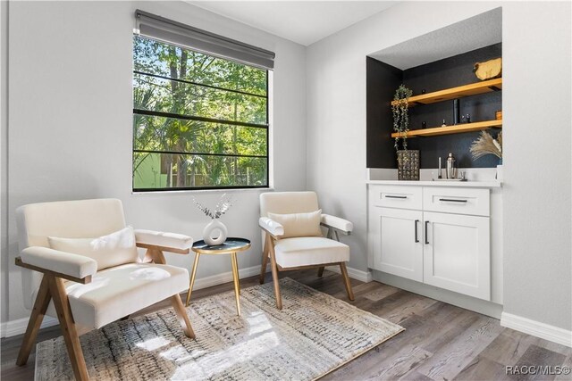 sitting room with light wood-style floors and baseboards