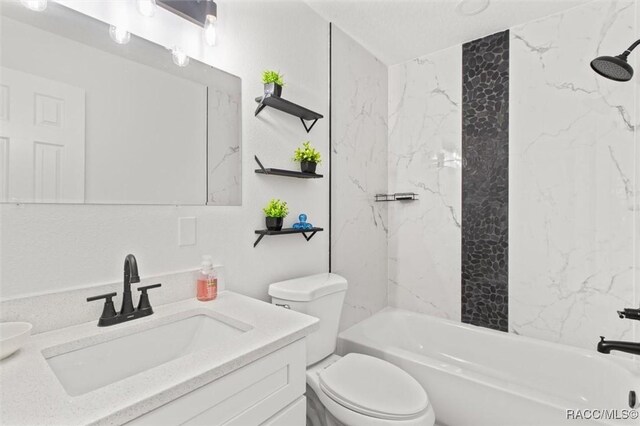 bathroom featuring toilet, vanity, and bathing tub / shower combination