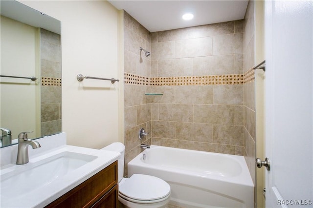 full bathroom featuring vanity, toilet, and tiled shower / bath